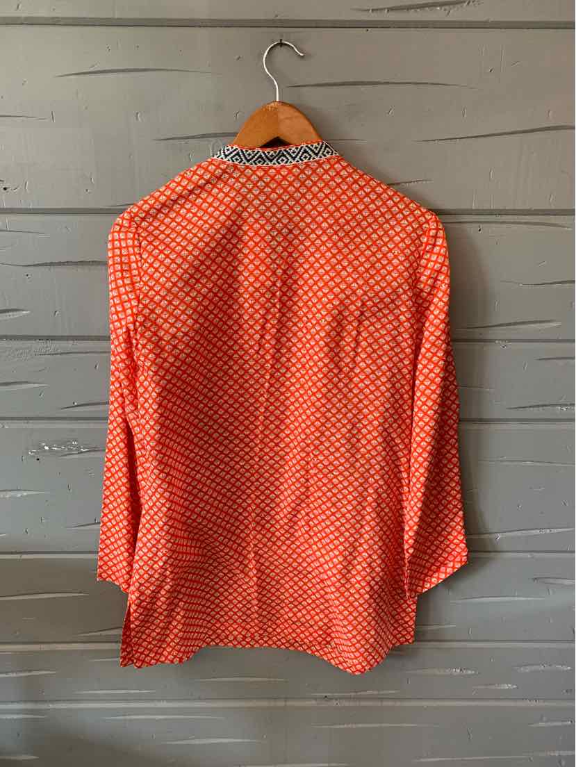 Long-sleeve button-up blouse in bright red with white geometric pattern and a classic collar.