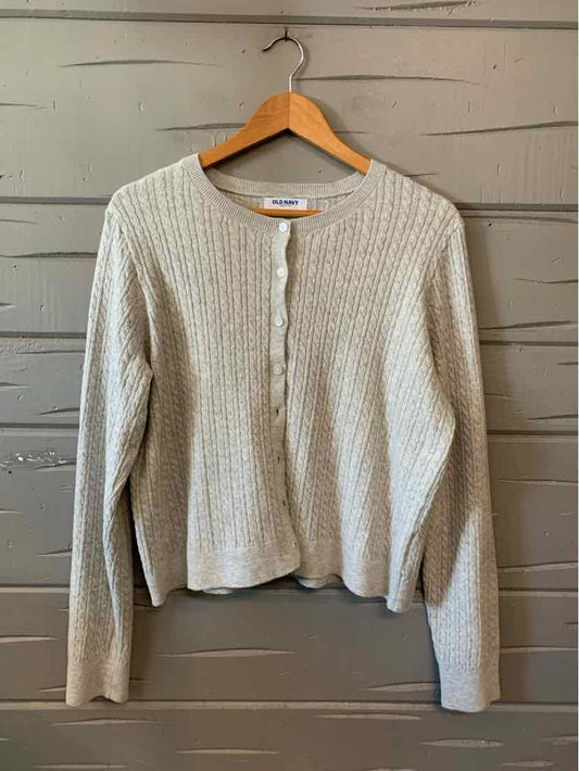 Light gray ribbed knit cardigan with long sleeves and a round neckline on a wooden hanger.