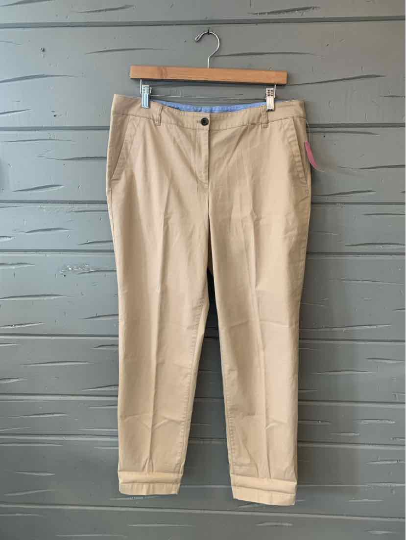 Khaki tailored women's trousers with belt loops and front pockets on wooden hanger.