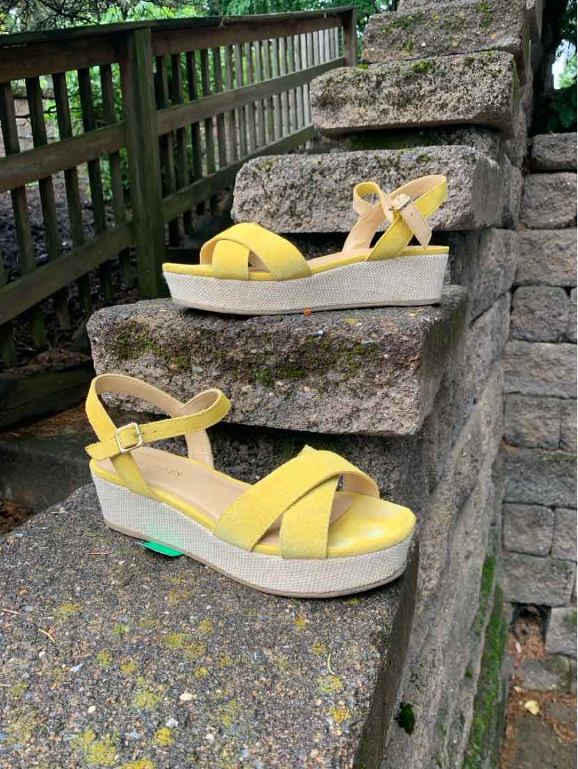 Yellow wedge sandals with ankle straps and white platform soles, size 7.5.
