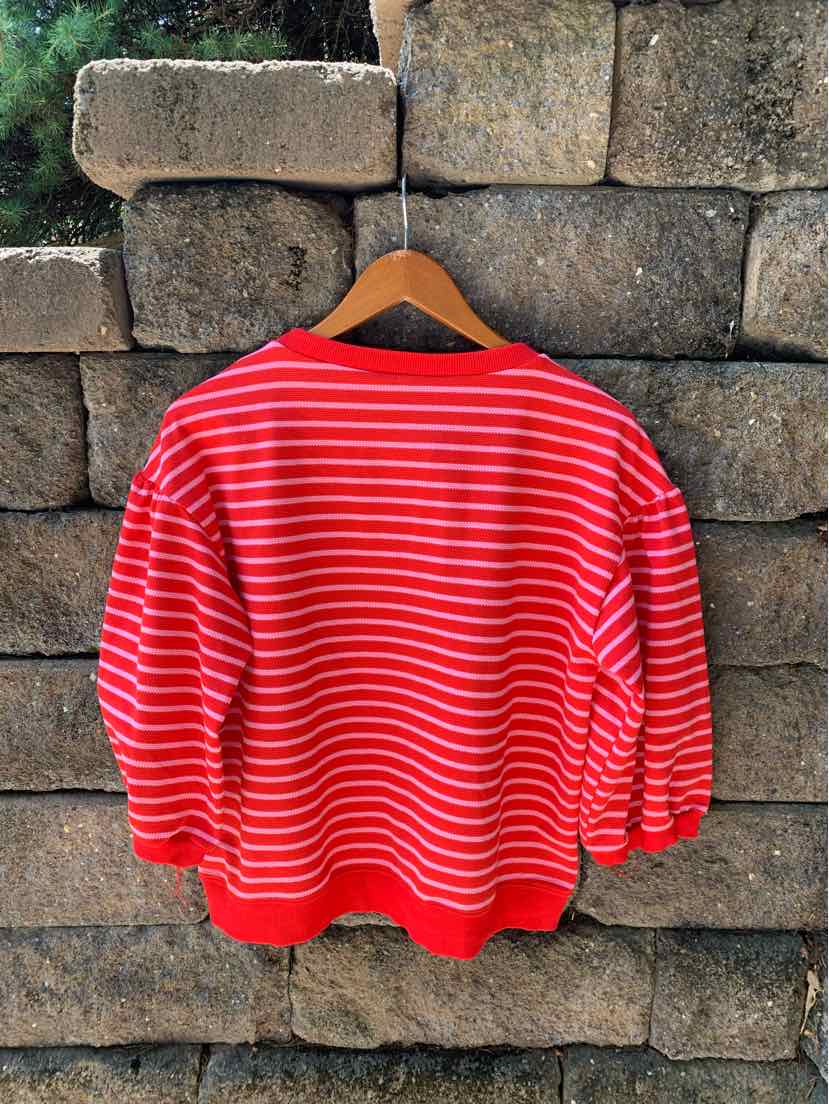 Red and white horizontal striped long-sleeve shirt with black neckline in medium size.