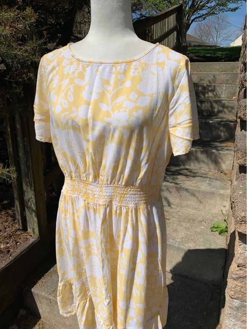 Yellow and white floral short-sleeve dress with cinched waist, crew neckline, and knee length.
