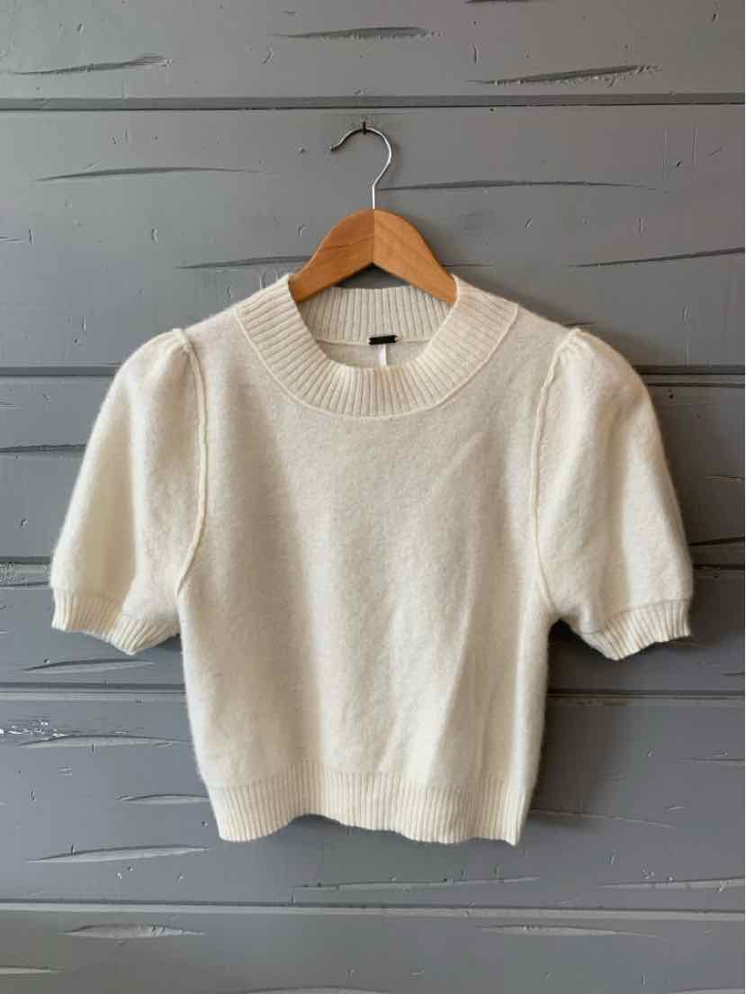Cream-colored short-sleeve knit sweater with puffed sleeves and ribbed crew neckline.