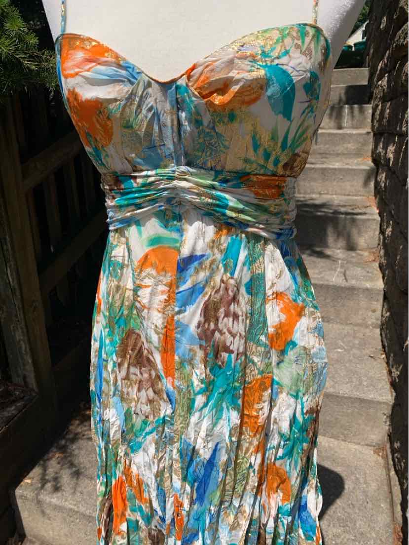 Sleeveless sundress with ruched bust, multicolor abstract floral print, fitted waist, and flowing skirt.
