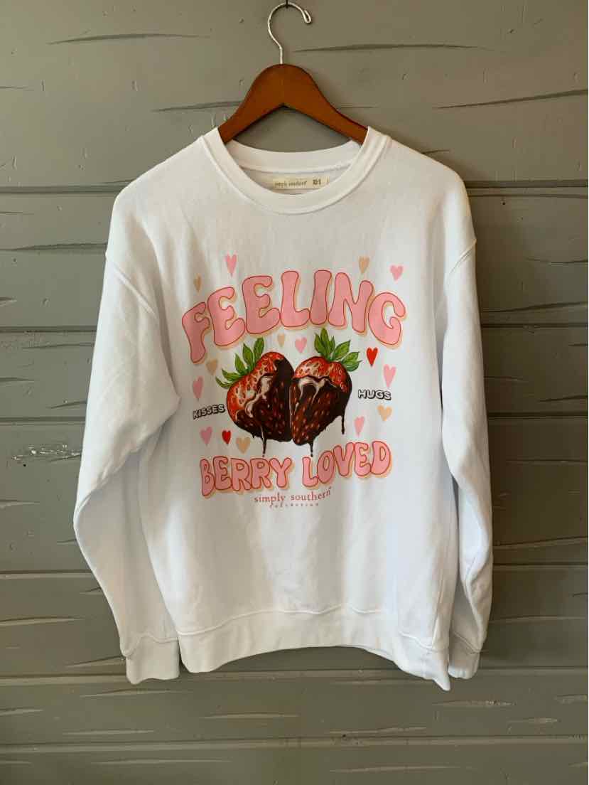 White crewneck sweatshirt with pink "Feeling Berry Loved" text and a graphic of strawberries and leaves.