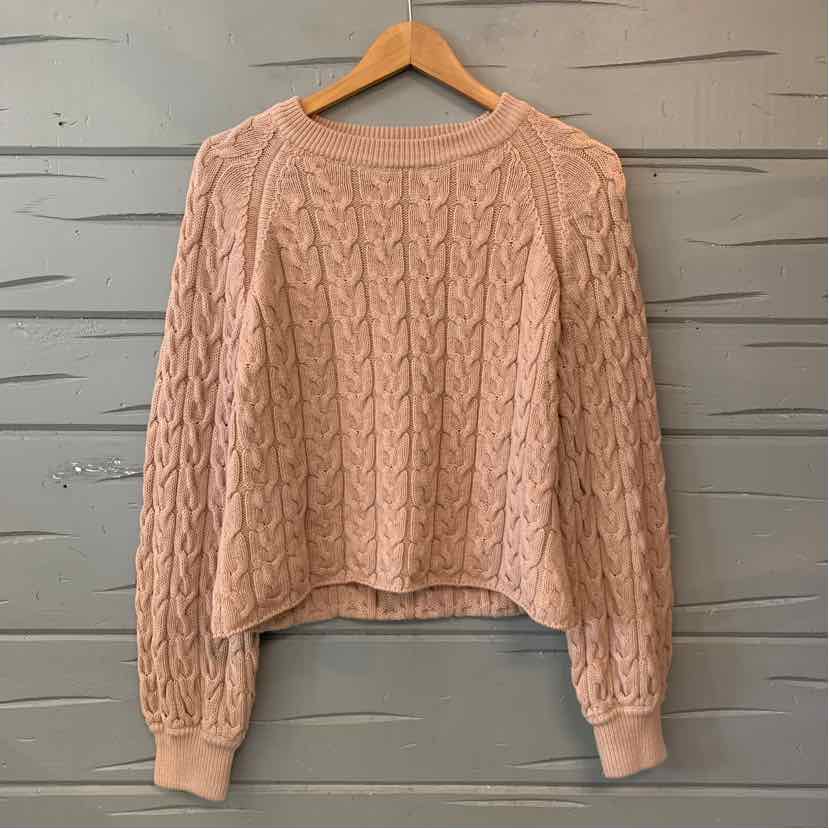 Tan J.Crew cable-knit sweater with a round neckline, long sleeves, and ribbed cuffs and hem.