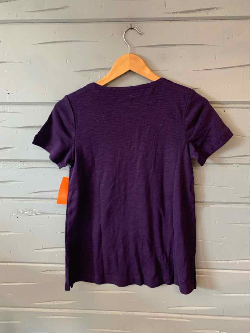 Purple short-sleeve knit top with scalloped hem on wooden hanger.