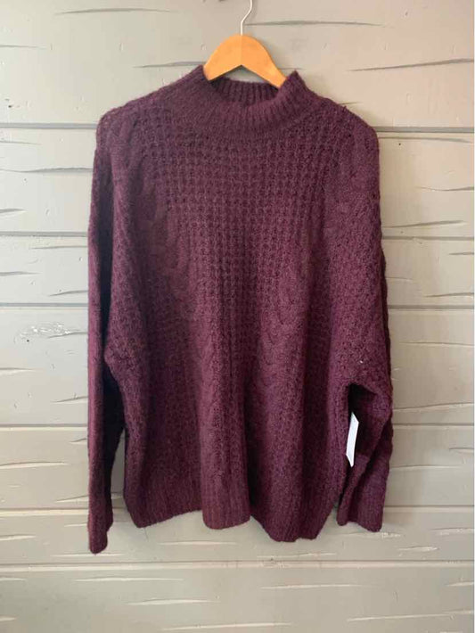 Burgundy oversized knit sweater with high neck and textured waffle pattern.