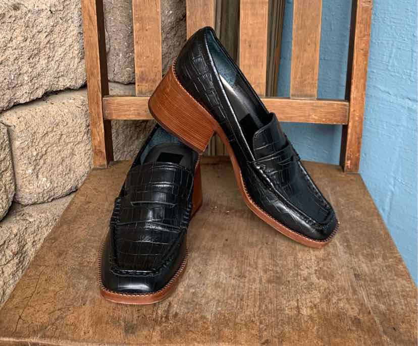 Black leather loafer with crocodile texture, square toe, and stacked wooden heel.