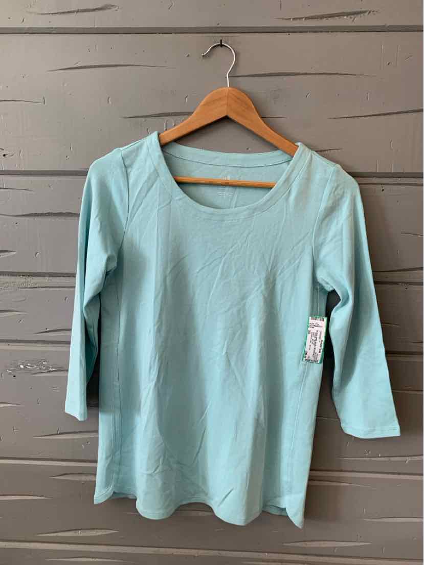 Light blue women's long-sleeve scoop neck top in size XS hanging on wooden hanger against gray wooden wall.
