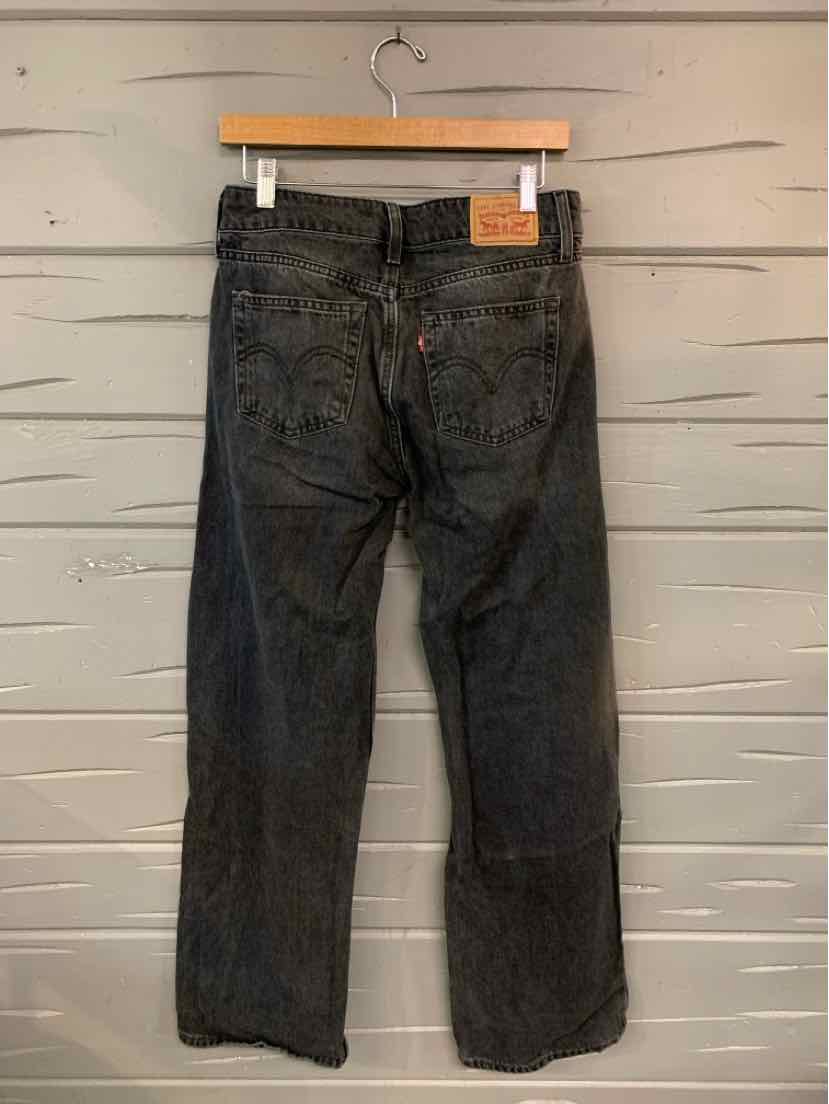 Black denim Levi's jeans with straight legs, visible back pockets, and a leather brand patch on the waistband.