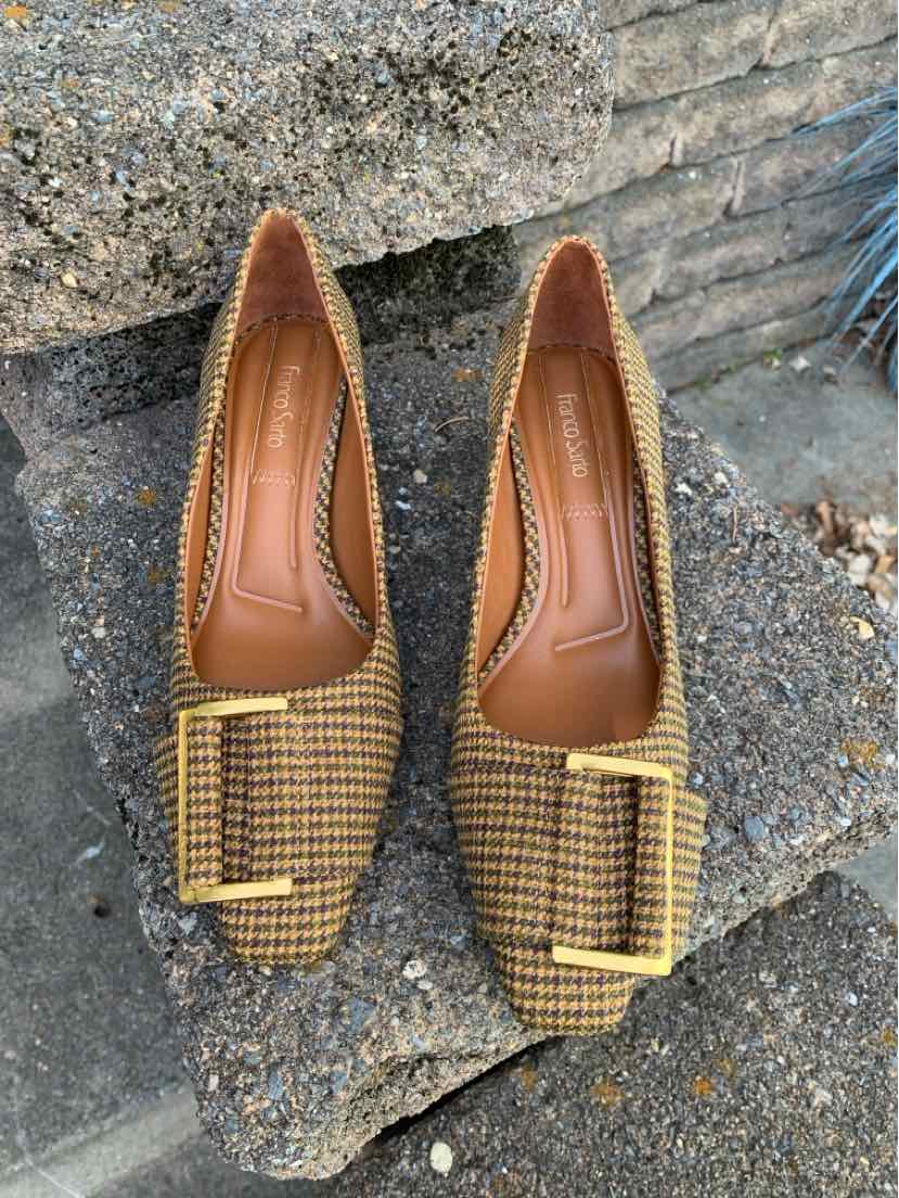 Pair of tan and black houndstooth Franco Sarto pointed-toe flats with buckle accents and cushioned insoles.