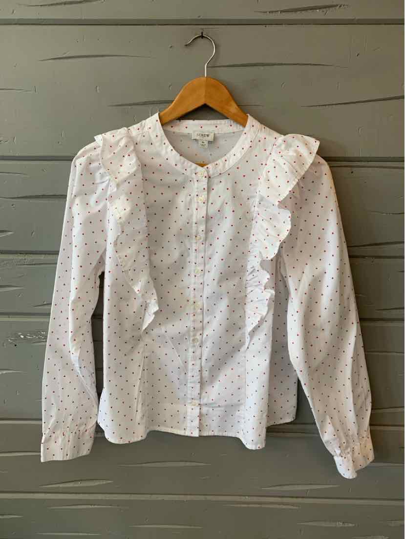 White long-sleeve blouse with small heart print, ruffled front panels, and a rounded collar on wooden hanger.
