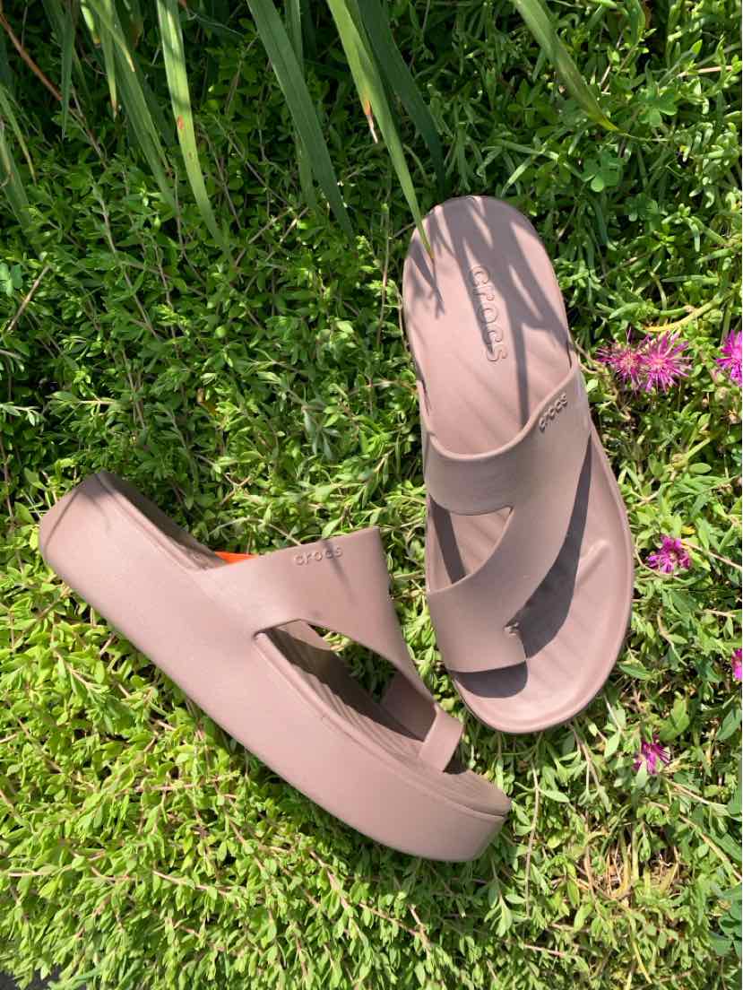 Beige slip-on sandal with two wide straps and textured footbed, size 9, lightweight foam material.