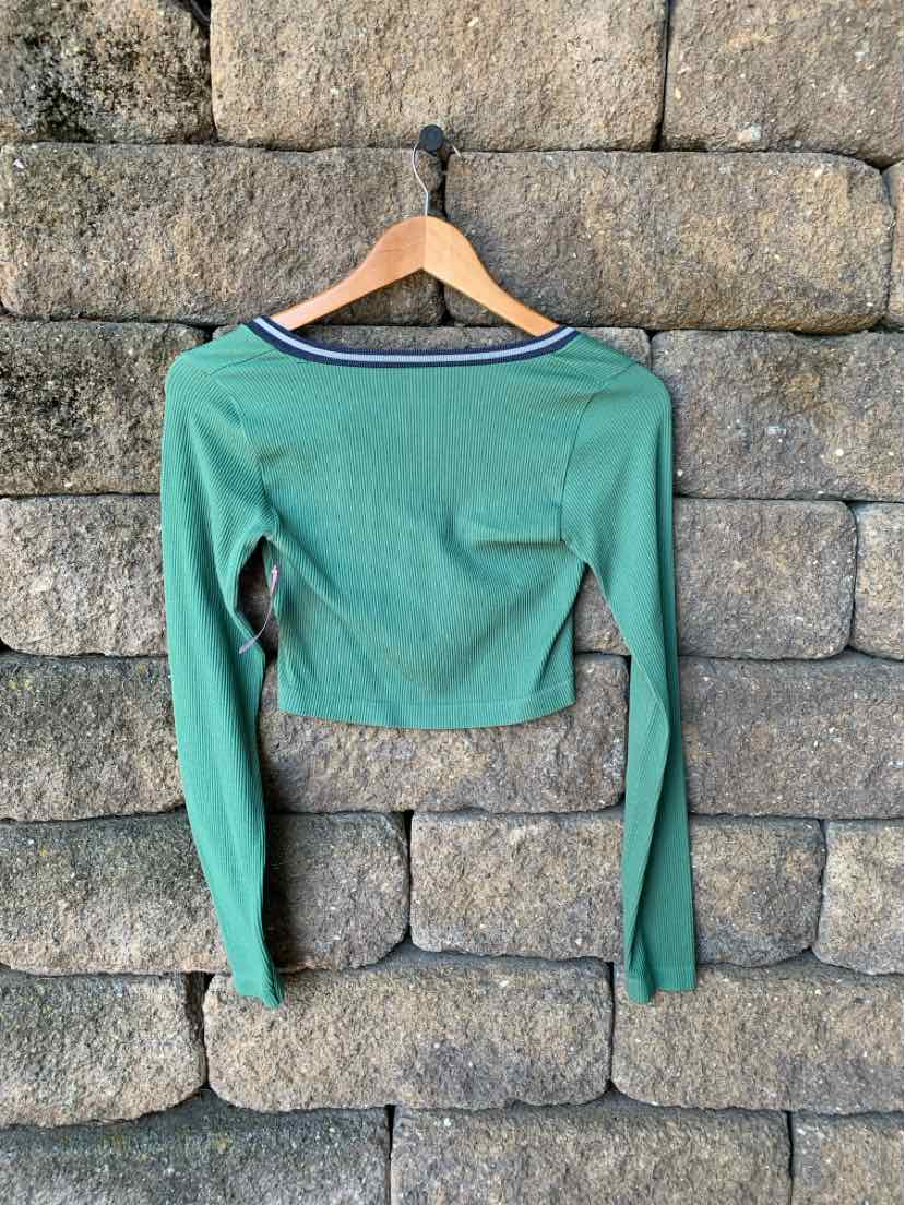Green ribbed long-sleeve crop top with boat neckline and small chest pocket.