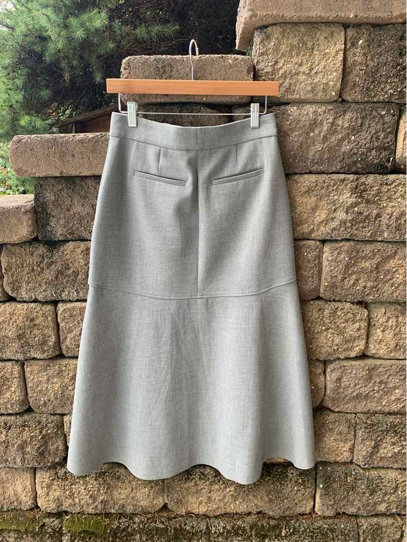 Light gray knee-length skirt with a slightly flared hem and two back welt pockets.