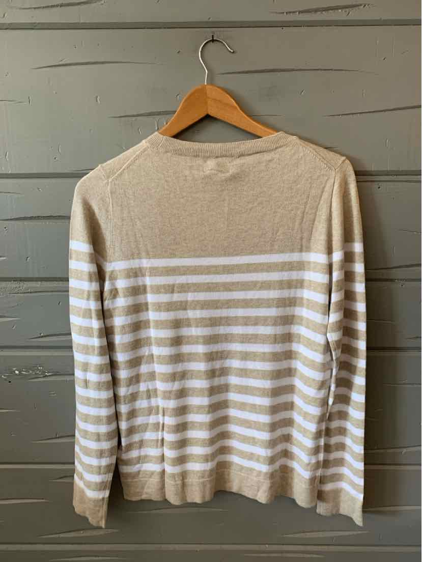 Beige knit sweater with white horizontal stripes and long sleeves hanging on wooden hanger.