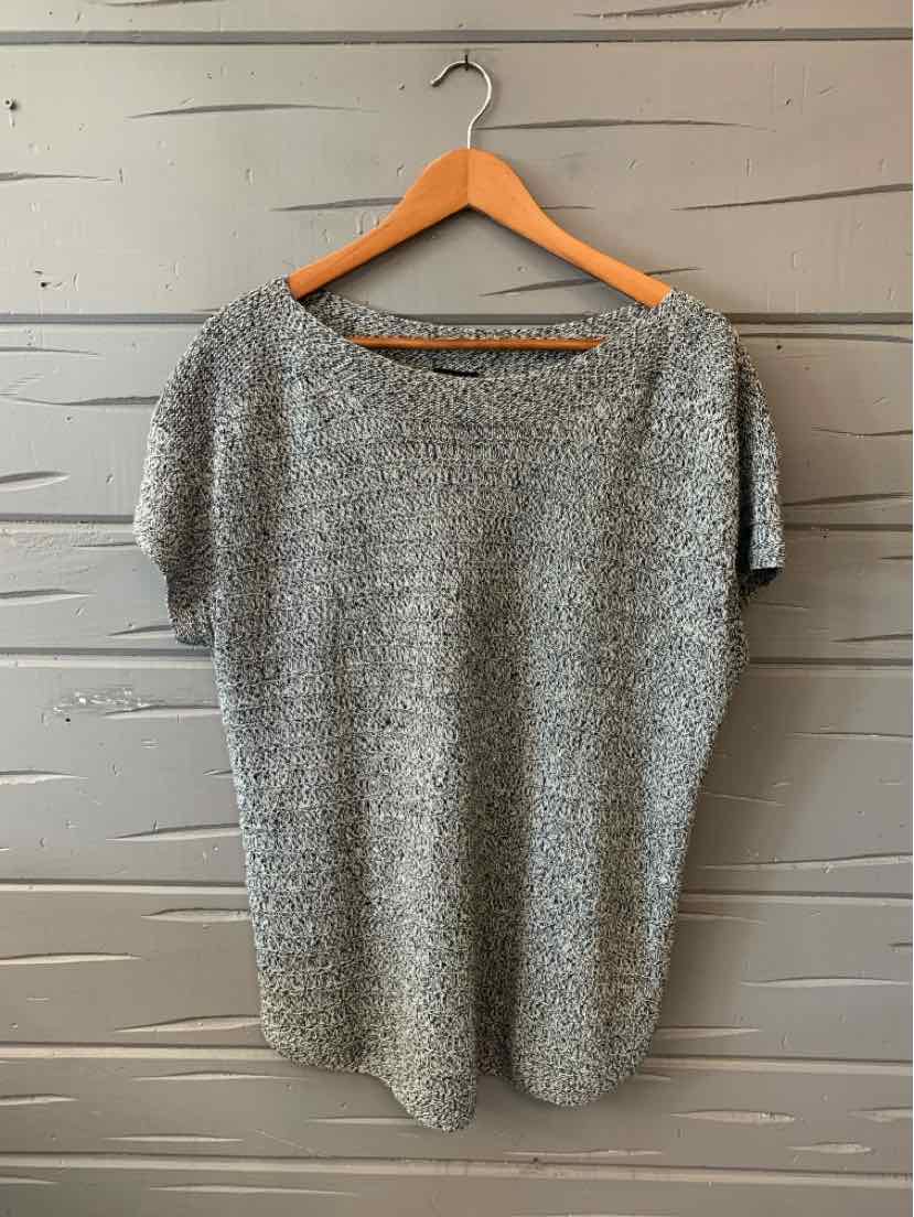 Light gray knit short-sleeve sweater with a relaxed fit and round neckline hanging on wooden hanger.