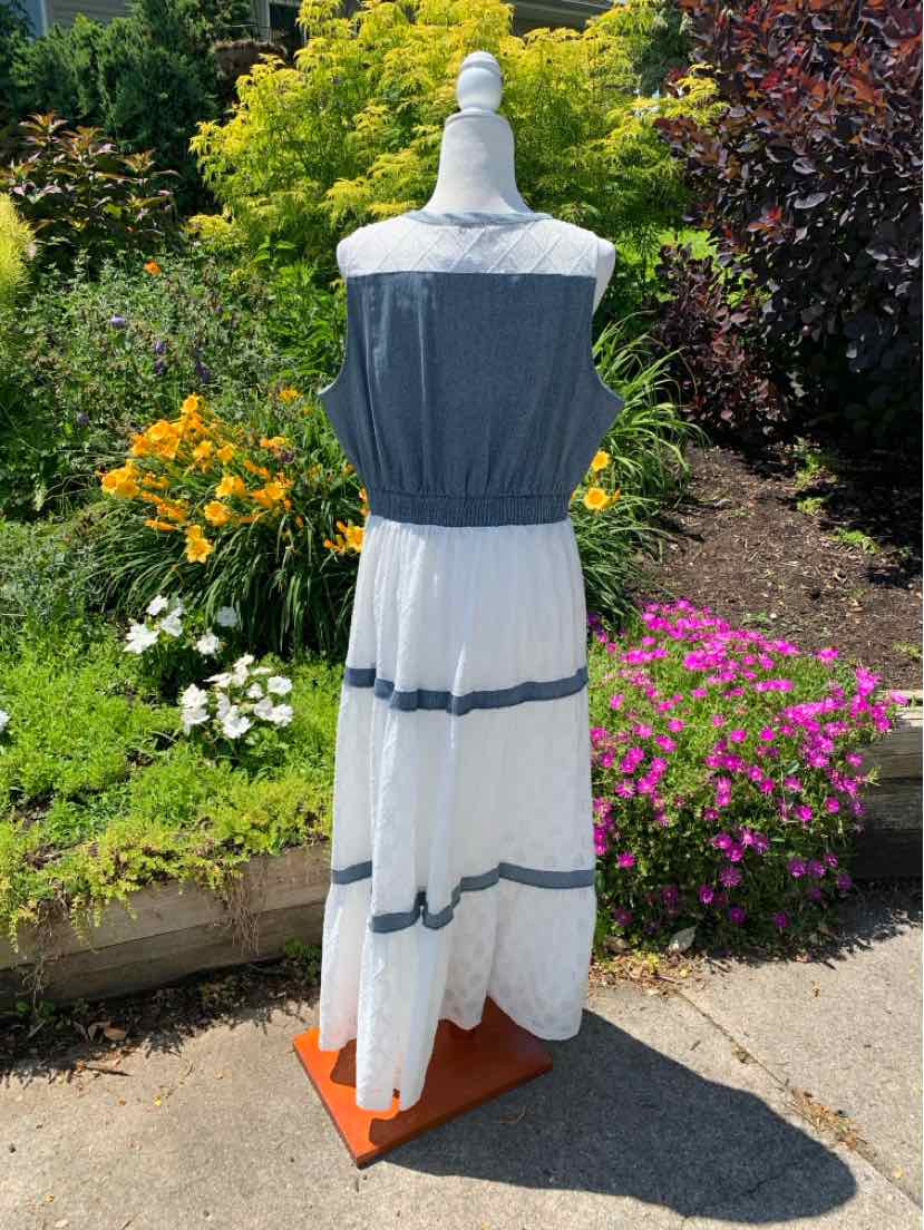 Sleeveless maxi dress with blue fitted bodice and white skirt featuring three horizontal blue stripes.