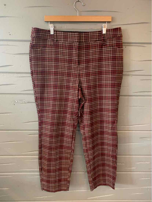 Red and black plaid women's pants with a straight-leg cut, size 18, hanging on a wooden hanger.