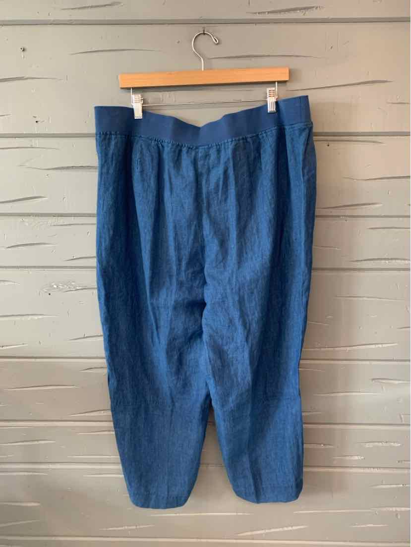 Blue high-waisted pants with tapered legs and pleated front, made of lightweight fabric.