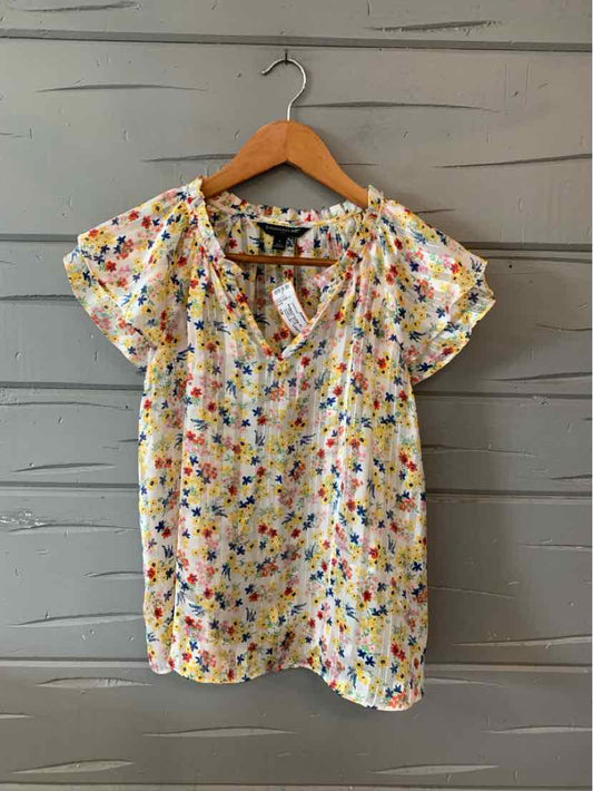Lightweight floral blouse with short flutter sleeves and a V-neck keyhole detail in multicolor on a cream background.