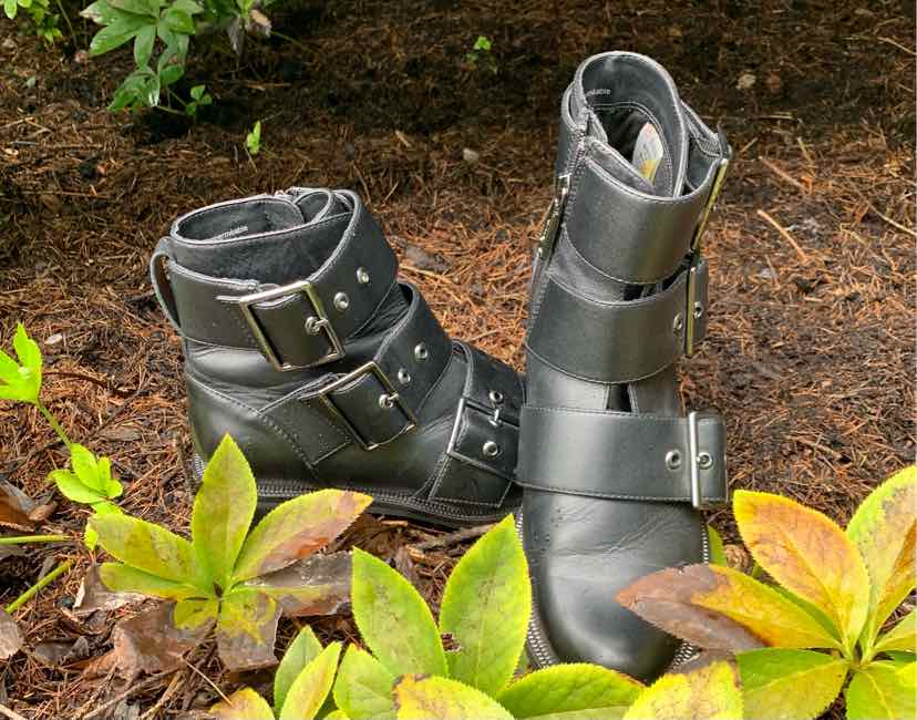 Black leather ankle boots with multiple adjustable buckle straps and a rounded toe.