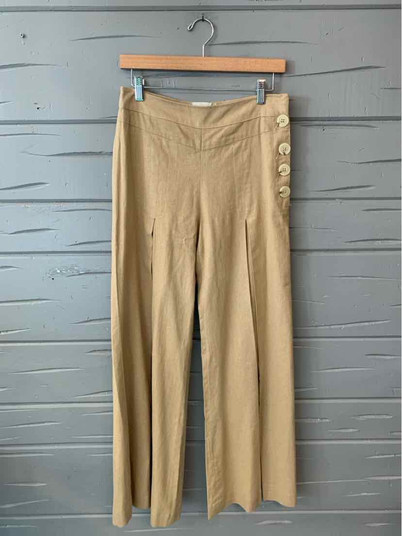 Tan high-waisted wide-leg pants with side button detailing in size 4 on wooden hanger.