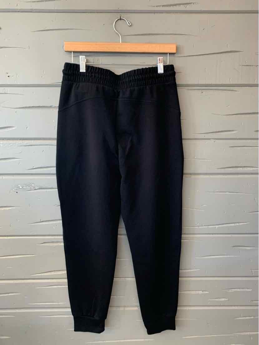 Black Old Navy women’s jogger pants with an elastic waistband, side pockets, and tapered cuffs.