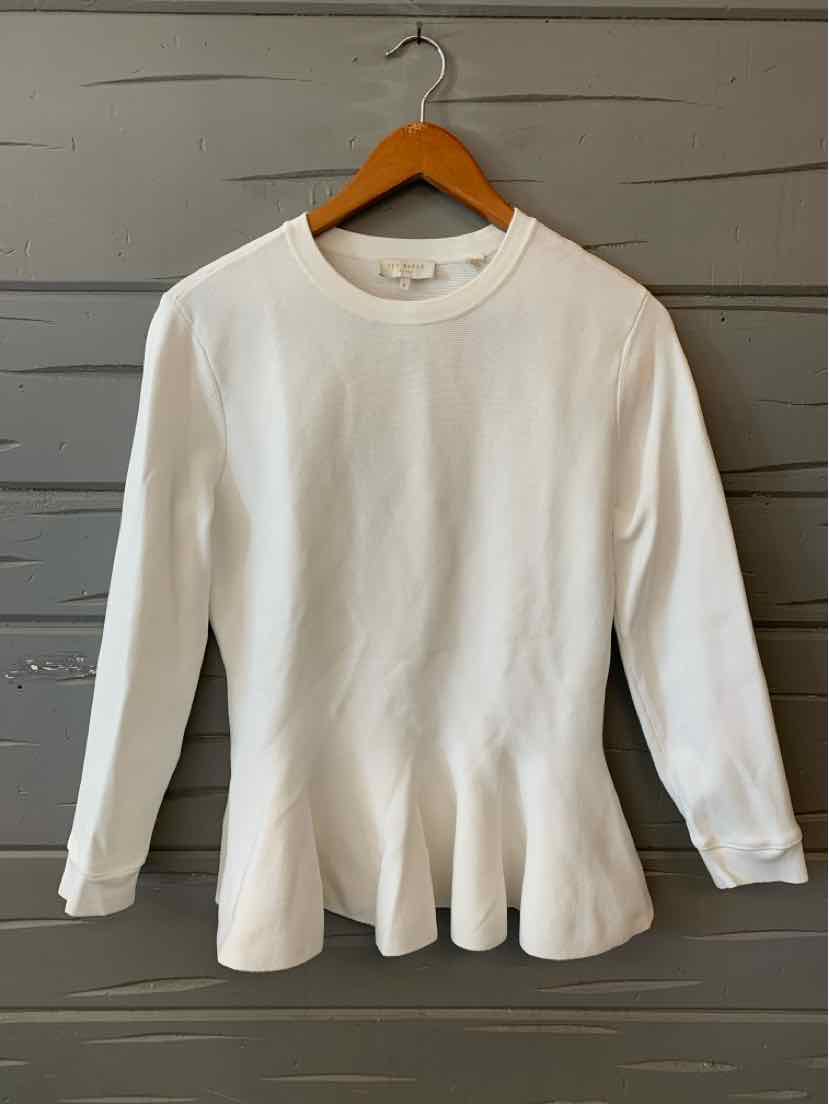White long-sleeve Ted Baker sweater with peplum hem and crew neckline.