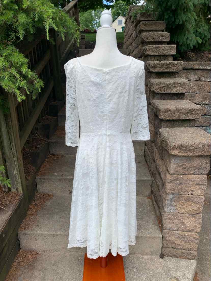 White lace dress with three-quarter sleeves, fitted waist, and flared skirt in size XL.