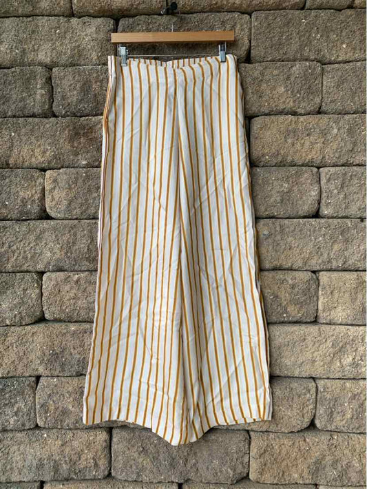 High-waisted wide-leg pants with vertical orange and white stripes, lightweight fabric, and a relaxed fit.