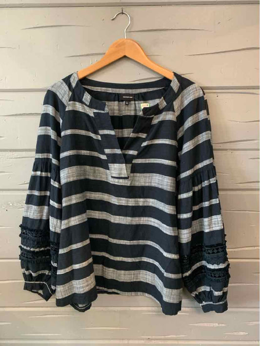 Black and white horizontal striped long-sleeve blouse with textured smocked cuffs and a split neckline.