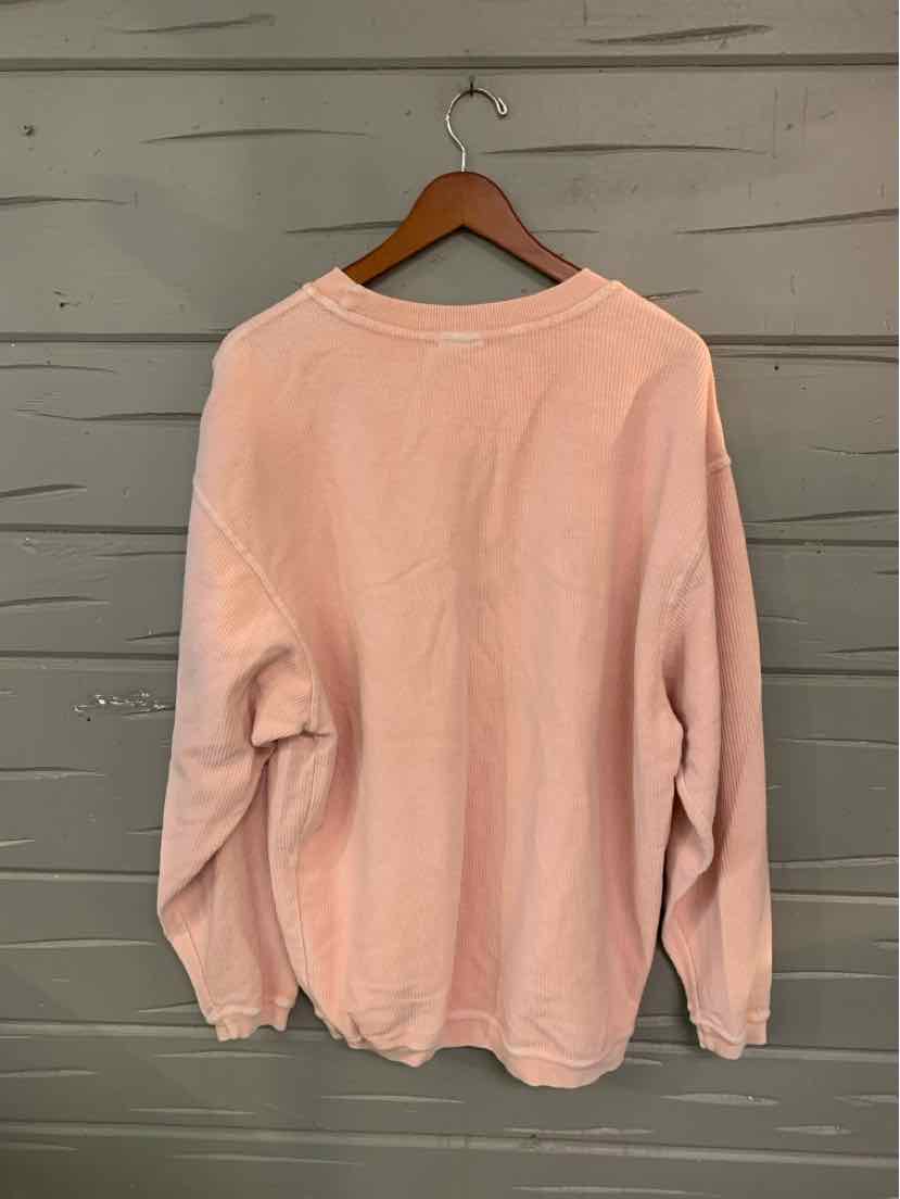 Light pink long-sleeve crewneck sweatshirt with relaxed fit and ribbed cuffs and hem.