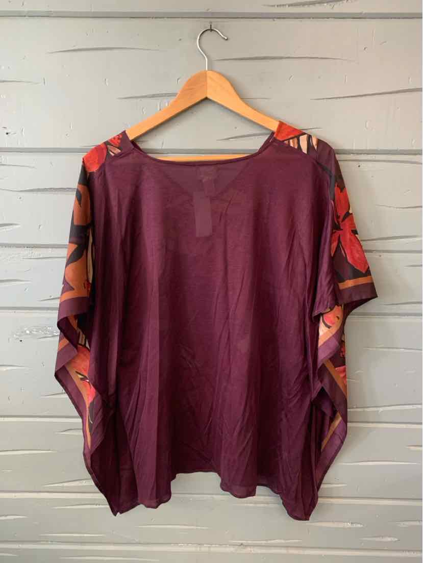 Purple loose-fit blouse with floral patterned open sleeves in red and brown tones.