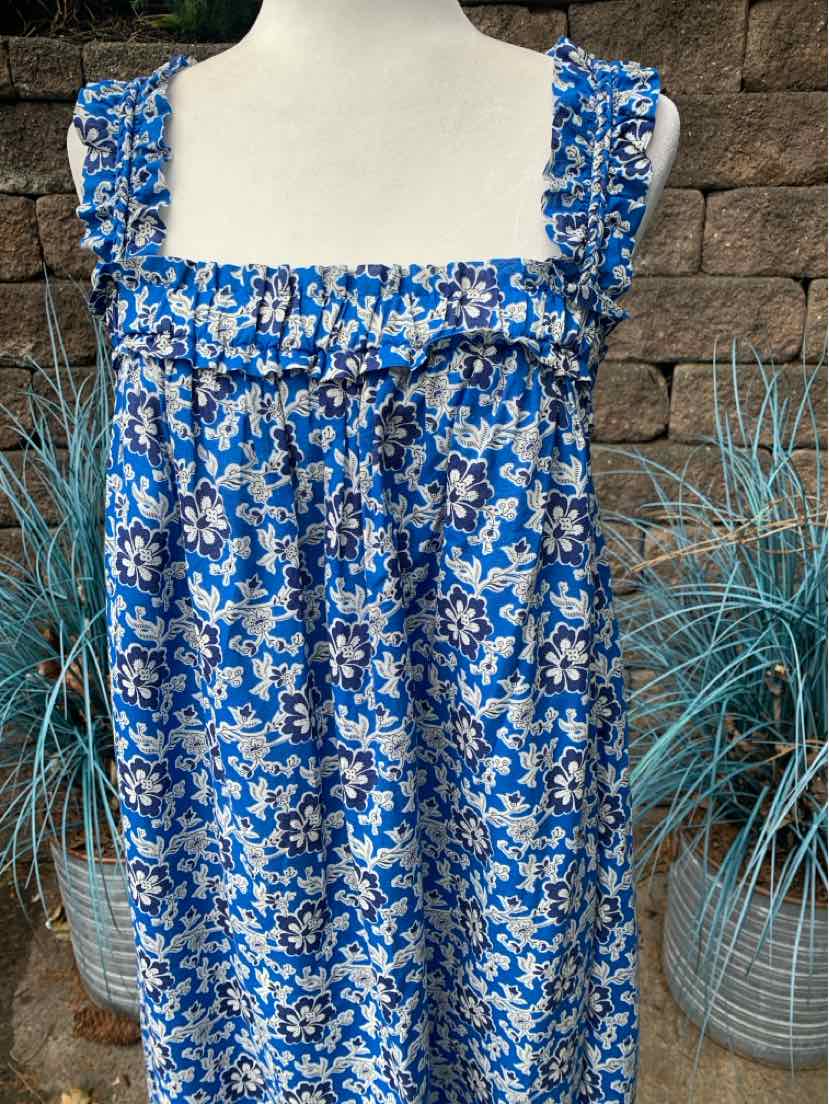 Blue floral smocked sundress with ruffled square neckline and wide shoulder straps.