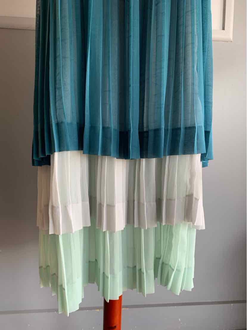 Teal and pastel pleated layered skirt with sheer fabric and color-block design in size 10.