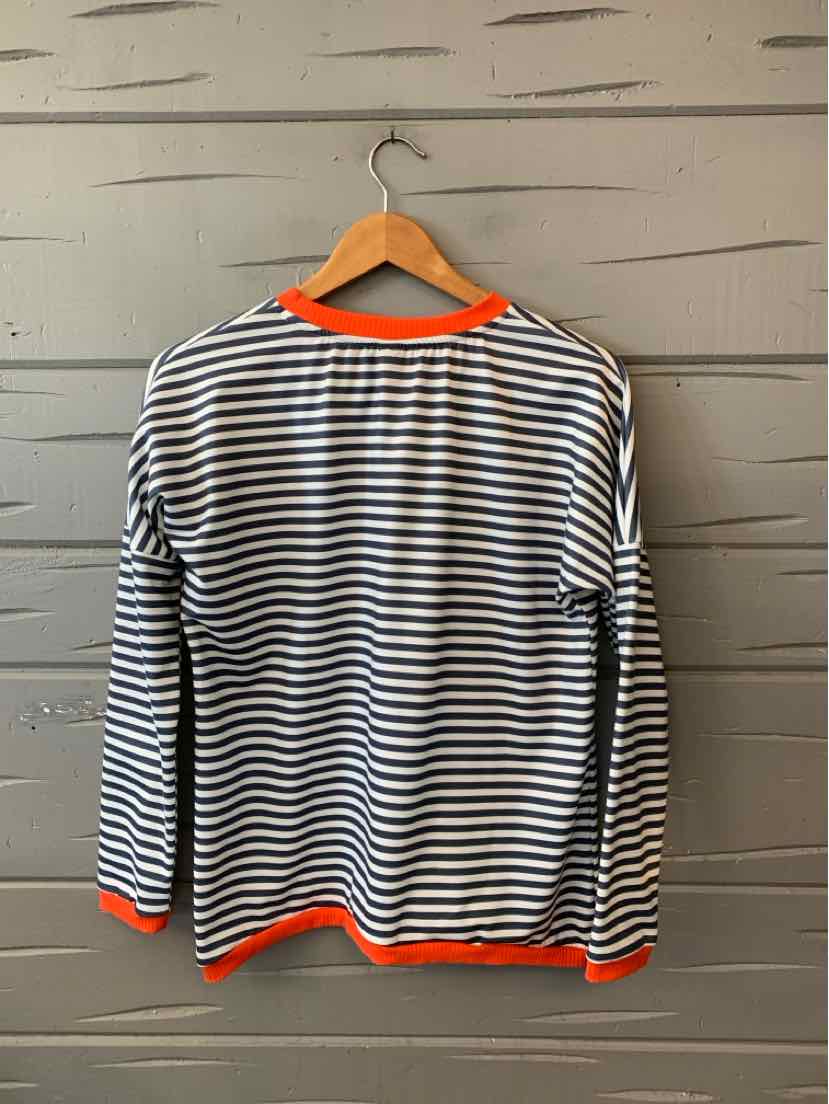 Women's black-and-white striped long-sleeve shirt with bright orange trim at the neckline, cuffs, and hem.