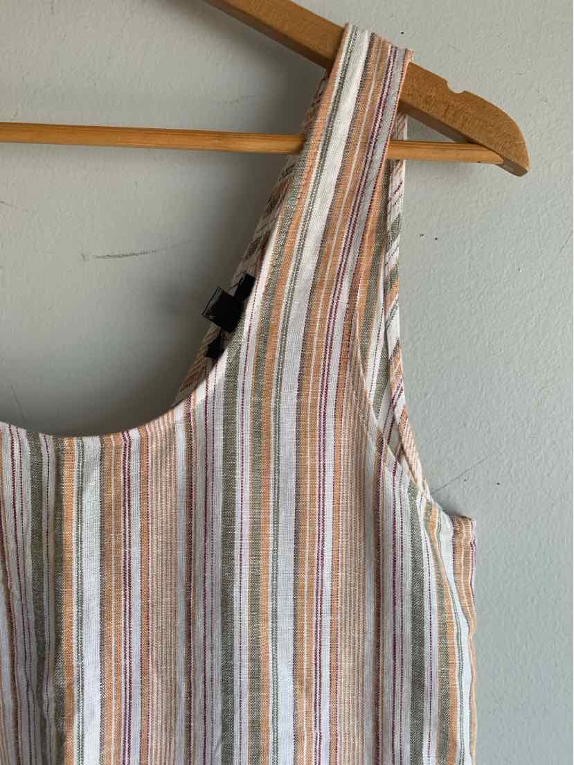 Sleeveless top with vertical brown, orange, white, and black stripes on a light fabric hanging on wooden hanger.