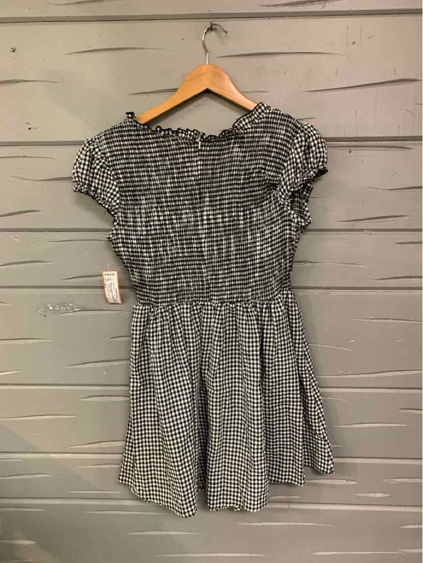Black and white gingham short-sleeve dress with smocked waist and ruffled neckline, medium size.