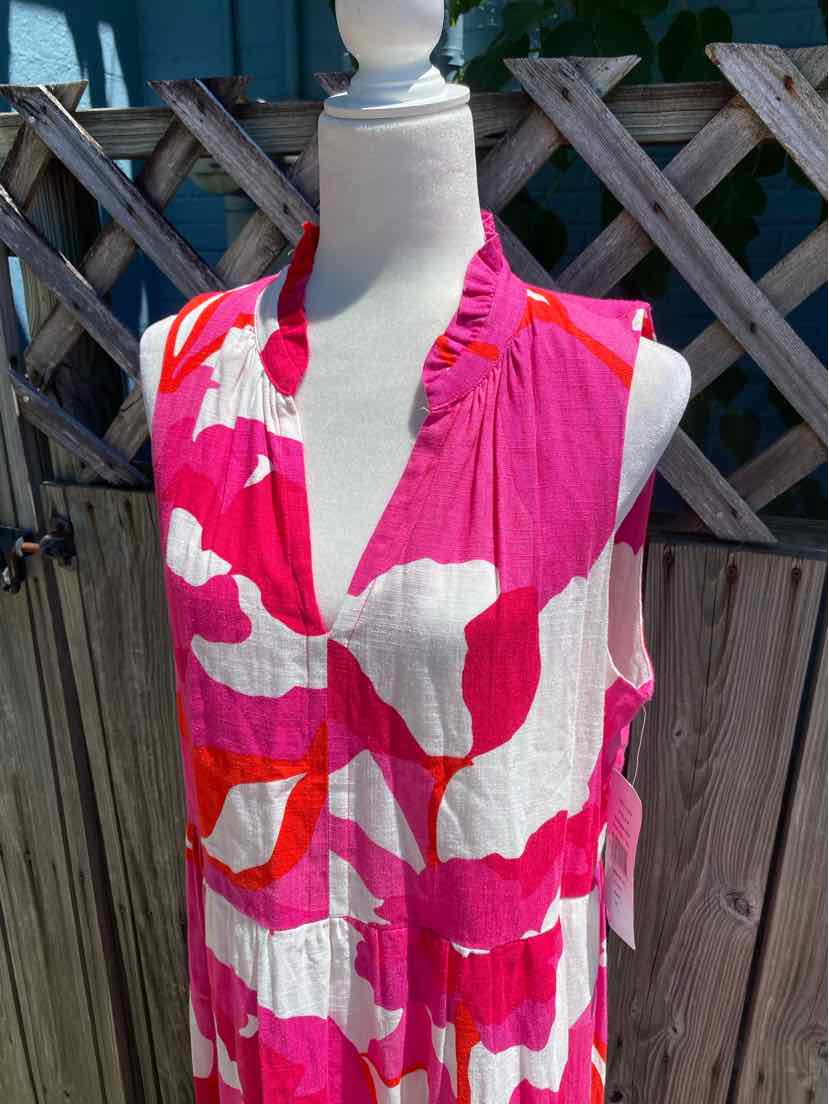 Sleeveless pink and white floral dress with ruffled V-neck collar on mannequin.