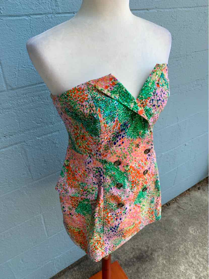 Strapless mini dress with vibrant multicolor abstract floral pattern and fitted silhouette.