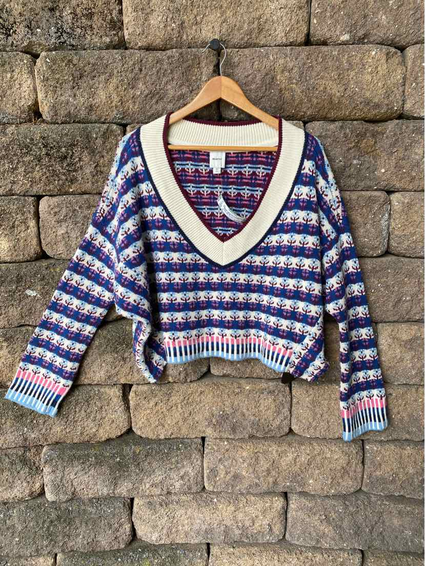 V-neck knit sweater with multicolor striped pattern, ribbed cuffs and hem, size XL.