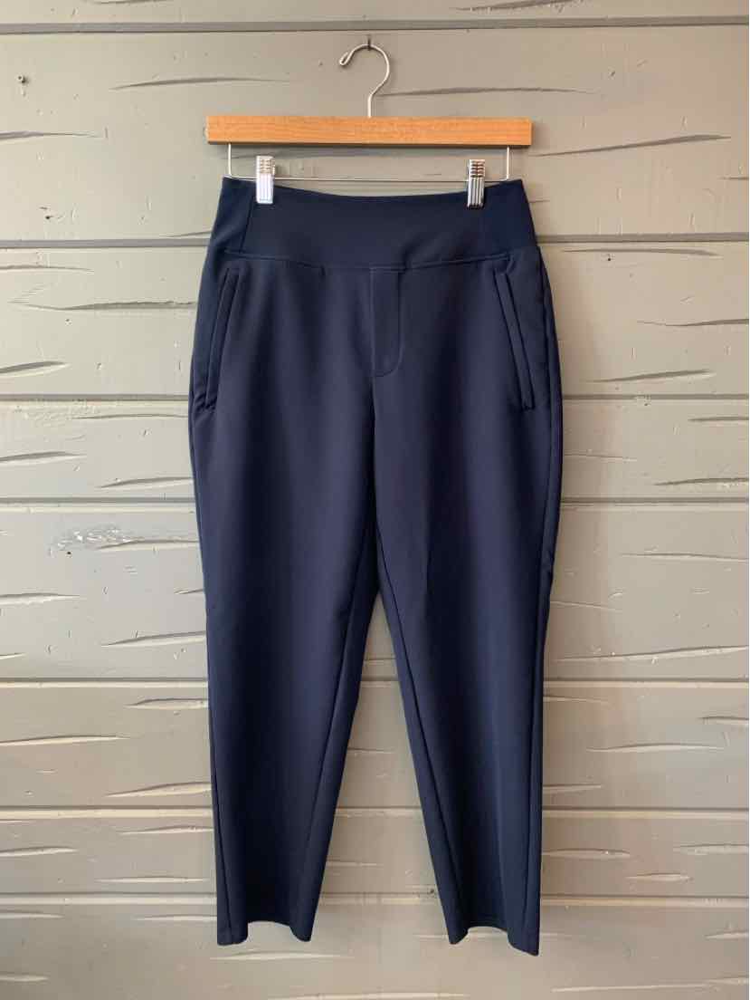 Navy blue high-waisted athletic leggings with side zip pocket and tapered legs.