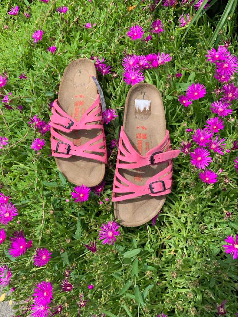 Pink Birkenstock sandals with double adjustable straps and contoured cork footbeds, size 38.