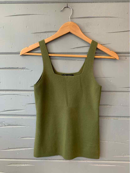 Olive green sleeveless square-neck knit tank top on wooden hanger against gray wall.