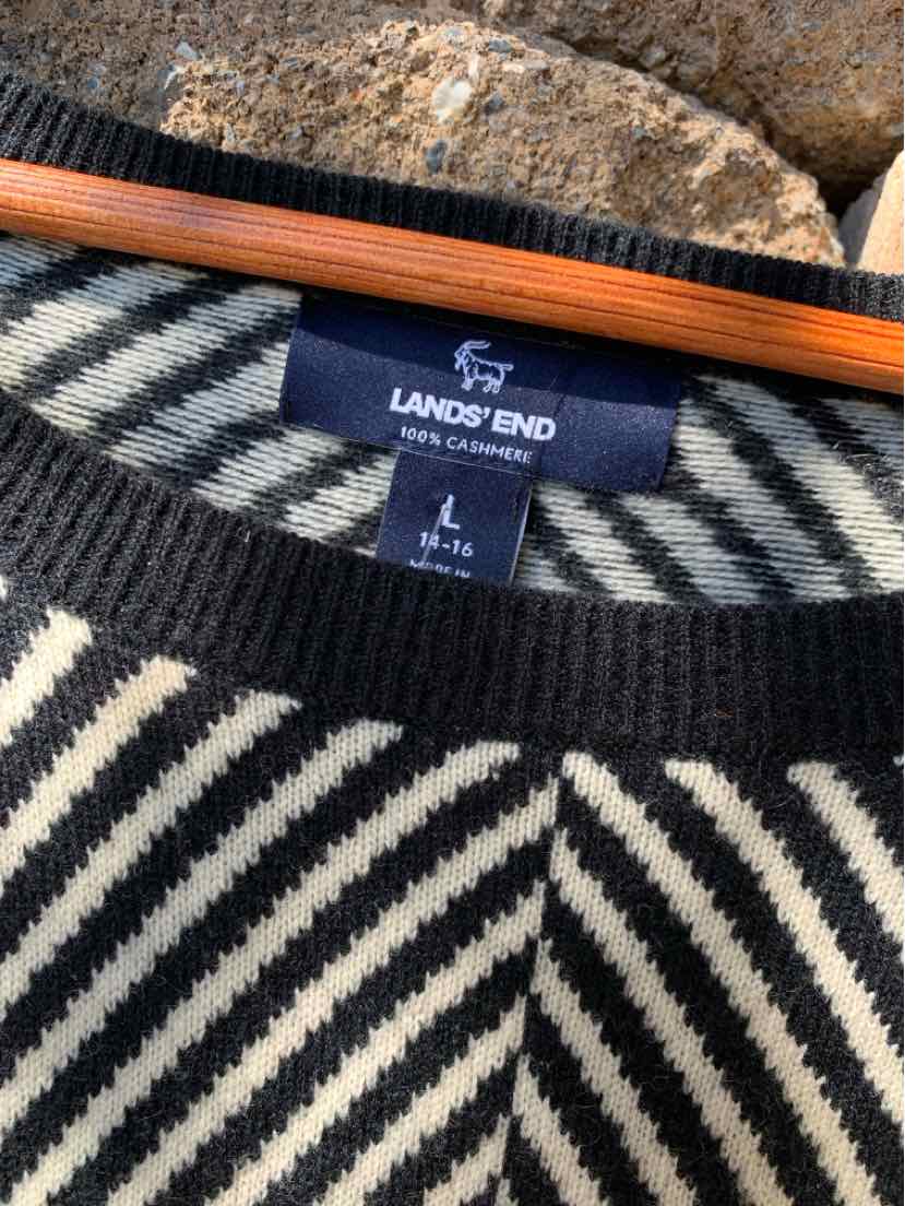 Black and white striped knit sweater with Lands' End label and crew neckline.