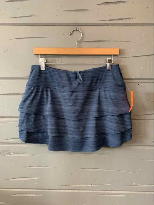 Navy blue athletic skirt with horizontal textured stripes and adjustable waistband with drawstring.