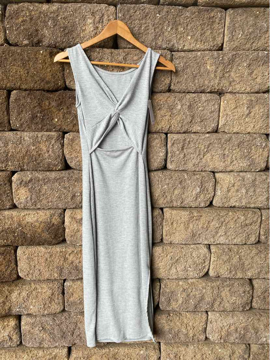 Light gray sleeveless midi dress with front knot detail and scoop neckline on wooden hanger.