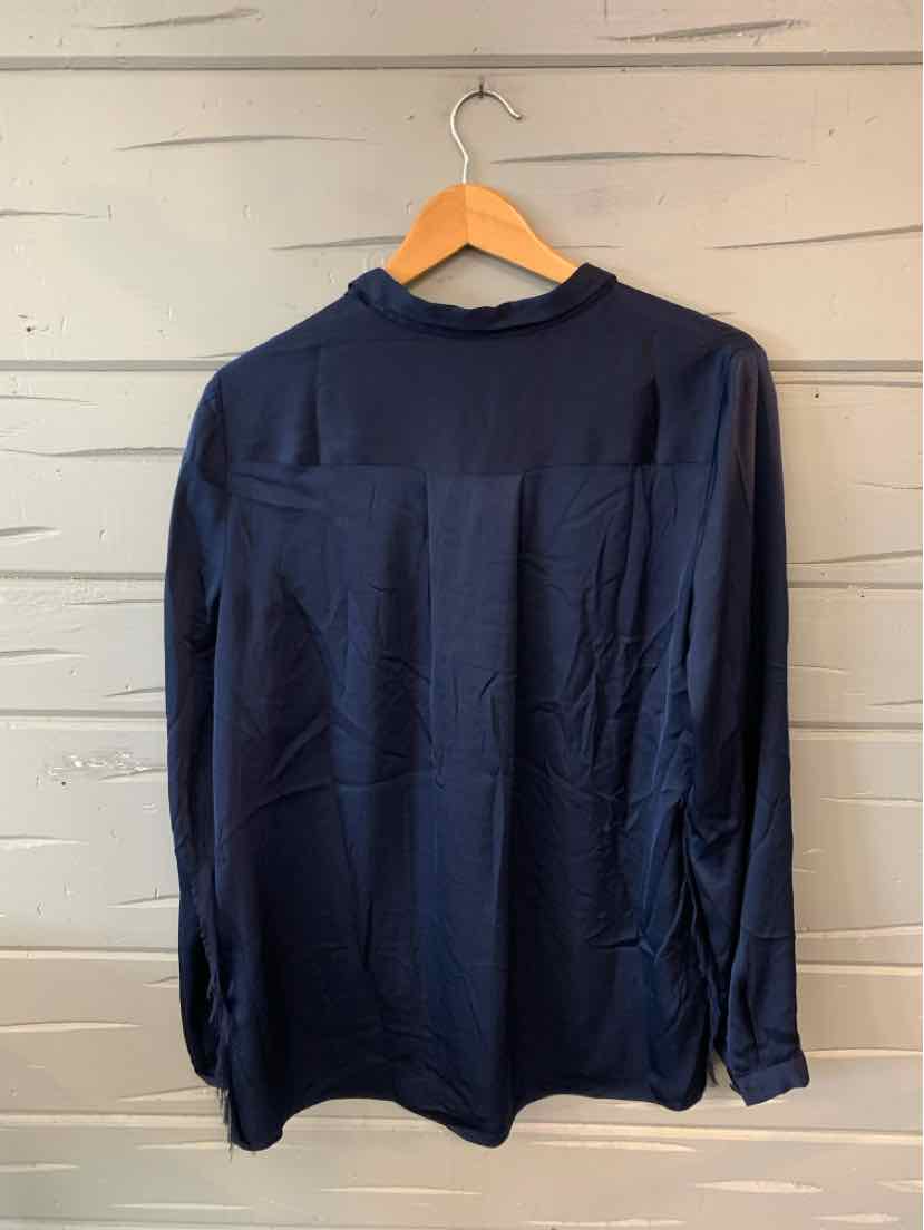 Navy blue long-sleeve blouse with a high collar and smooth lightweight fabric hanging on wooden hanger.